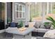 Enclosed patio with cozy seating, fire table, and views of the surrounding nature at 370 Chapel Ridge Dr, Pittsboro, NC 27312