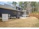 Back exterior view of a home with a covered patio, grill, and well-maintained lawn at 370 Chapel Ridge Dr, Pittsboro, NC 27312