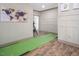 Finished recreation room featuring custom putting green, hardwood floors, and wainscoting at 370 Chapel Ridge Dr, Pittsboro, NC 27312