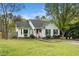 Charming single-Gathering home featuring a manicured lawn, inviting entryway, and classic architectural details at 3708 Turnbull Ct, Raleigh, NC 27616