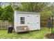 Storage shed with double doors, a window, bench, pillow, and grill at 3708 Turnbull Ct, Raleigh, NC 27616