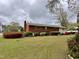 Spacious backyard featuring lush greenery, mature trees and brick exterior at 3711 Halford Dr, Raleigh, NC 27604