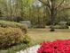 Spacious backyard with a shed, seating area, firepit and mature trees at 3711 Halford Dr, Raleigh, NC 27604