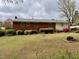 Expansive backyard with lush greenery and a brick home featuring a cozy outdoor fire pit at 3711 Halford Dr, Raleigh, NC 27604