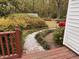 A tranquil backyard with a winding gravel path, lush bushes and mature trees at 3711 Halford Dr, Raleigh, NC 27604