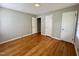 Bedroom featuring hardwood floors, neutral walls and three doors at 3711 Halford Dr, Raleigh, NC 27604