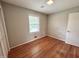 Bedroom with hardwood floors, closet and window at 3711 Halford Dr, Raleigh, NC 27604