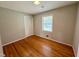 Bedroom featuring hardwood floors, neutral walls, closet and large window at 3711 Halford Dr, Raleigh, NC 27604