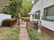 Lovely outdoor deck featuring a dining set and a walkway through the manicured yard at 3711 Halford Dr, Raleigh, NC 27604