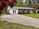 Charming brick home with white trim, double doors, landscaped yard and a spacious driveway at 3711 Halford Dr, Raleigh, NC 27604
