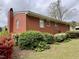 Brick home exterior with lush landscaping featuring colorful azalea bushes at 3711 Halford Dr, Raleigh, NC 27604