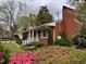 Brick home exterior featuring manicured landscaping and a cozy front porch at 3711 Halford Dr, Raleigh, NC 27604