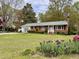 Brick ranch home featuring a large front yard with mature landscaping at 3711 Halford Dr, Raleigh, NC 27604