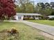 Charming brick home with well-manicured lawn and a long driveway at 3711 Halford Dr, Raleigh, NC 27604