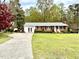 Charming brick home features a well-manicured lawn, a basketball hoop, and a long driveway at 3711 Halford Dr, Raleigh, NC 27604