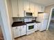 Functional kitchen featuring white appliances, cabinets, and backsplash design at 3711 Halford Dr, Raleigh, NC 27604