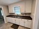 Kitchen with stainless steel sink and brown countertops, accented by white cabinets at 3711 Halford Dr, Raleigh, NC 27604