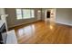 Living room with hardwood floors, brick fireplace, large windows, and neutral paint throughout at 3711 Halford Dr, Raleigh, NC 27604