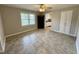 Well-lit living area featuring neutral walls, a large window, built-in storage and doorway to kitchen at 3711 Halford Dr, Raleigh, NC 27604