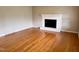 Inviting living room features gleaming hardwood floors and a cozy fireplace at 3711 Halford Dr, Raleigh, NC 27604
