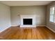 Bright living room with a brick fireplace and large window, offering ample natural light at 3711 Halford Dr, Raleigh, NC 27604