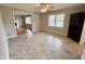 Open living space featuring ample lighting, tile floor, and a connecting den at 3711 Halford Dr, Raleigh, NC 27604