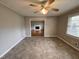 Inviting living room featuring a ceiling fan, neutral walls, and an open doorway to another living space at 3711 Halford Dr, Raleigh, NC 27604
