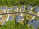 An aerial view shows an orderly neighborhood with manicured lawns, tree-lined streets, and well-maintained homes at 374 Ashley Woods Ct, Clayton, NC 27527