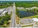 High angle view showcasing commercial area and nearby neighborhood close to a pond and lush wooded area at 374 Ashley Woods Ct, Clayton, NC 27527