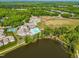 High angle view featuring neighborhood amenities including pool, clubhouse, tennis courts and adjacent lake at 374 Ashley Woods Ct, Clayton, NC 27527