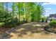 Lush backyard with mature trees, landscaping, and a well-maintained lawn at 374 Ashley Woods Ct, Clayton, NC 27527