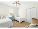 Charming bedroom with twin beds, a blue bedside table, window, and a spacious closet at 374 Ashley Woods Ct, Clayton, NC 27527
