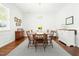 Bright dining room with hardwood floors, wainscoting, elegant chandelier, and a dining table for eight at 374 Ashley Woods Ct, Clayton, NC 27527