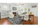 Bright living room with built-in shelves, a fireplace, and hardwood floors with a black rug at 374 Ashley Woods Ct, Clayton, NC 27527
