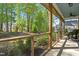 Inviting screened porch with views of the lush green landscape and a comfortable rocking chair at 374 Ashley Woods Ct, Clayton, NC 27527