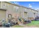 Spacious backyard with a wooden deck, string lights, plants, and a grassy area, ideal for entertaining at 4 Scottish Ln, Durham, NC 27707