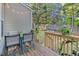 Inviting backyard deck with outdoor seating, plants, and a view of the fenced yard and lush trees at 4 Scottish Ln, Durham, NC 27707