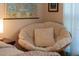 Cozy papasan chair with soft cushions, set near a window, and next to the main bedroom at 4 Scottish Ln, Durham, NC 27707