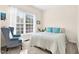 Bright bedroom with a large window, plush chair, and a comfortable bed with blue pillows at 4 Scottish Ln, Durham, NC 27707