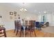 Bright dining room with hardwood floors, modern chandelier, and cozy seating area at 4 Scottish Ln, Durham, NC 27707