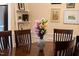 Lovely dining area with a dark wood table and matching chairs centered with a vase of fresh flowers at 4 Scottish Ln, Durham, NC 27707