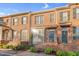 Charming brick townhomes with manicured landscaping, wrought iron railings, and inviting entryways at 4 Scottish Ln, Durham, NC 27707