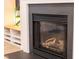 Close-up of the fireplace featuring a black mantel and hearth, with decorative shelving nearby at 4 Scottish Ln, Durham, NC 27707