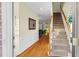 Inviting foyer with hardwood floors, paneled walls, and staircase leading to upper level at 4 Scottish Ln, Durham, NC 27707