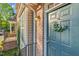 Charming front door with wreath, brick accents, and well-maintained landscaping adding to the home's appeal at 4 Scottish Ln, Durham, NC 27707