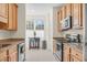 Well-lit kitchen with wooden cabinets, granite countertops, stainless steel appliances, and an adjacent breakfast nook at 4 Scottish Ln, Durham, NC 27707