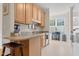 Spacious kitchen with light wood cabinets, granite countertops, stainless steel appliances, and an adjacent breakfast nook at 4 Scottish Ln, Durham, NC 27707