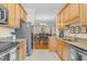 Kitchen featuring stainless steel appliances, granite countertops, and view of the dining area at 4 Scottish Ln, Durham, NC 27707