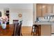 Open-concept dining space with an adjacent kitchen featuring a breakfast bar and eat-in area at 4 Scottish Ln, Durham, NC 27707