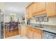 Bright kitchen featuring wood cabinets, granite countertops, stainless appliances, and an eat-in area overlooking the dining room at 4 Scottish Ln, Durham, NC 27707